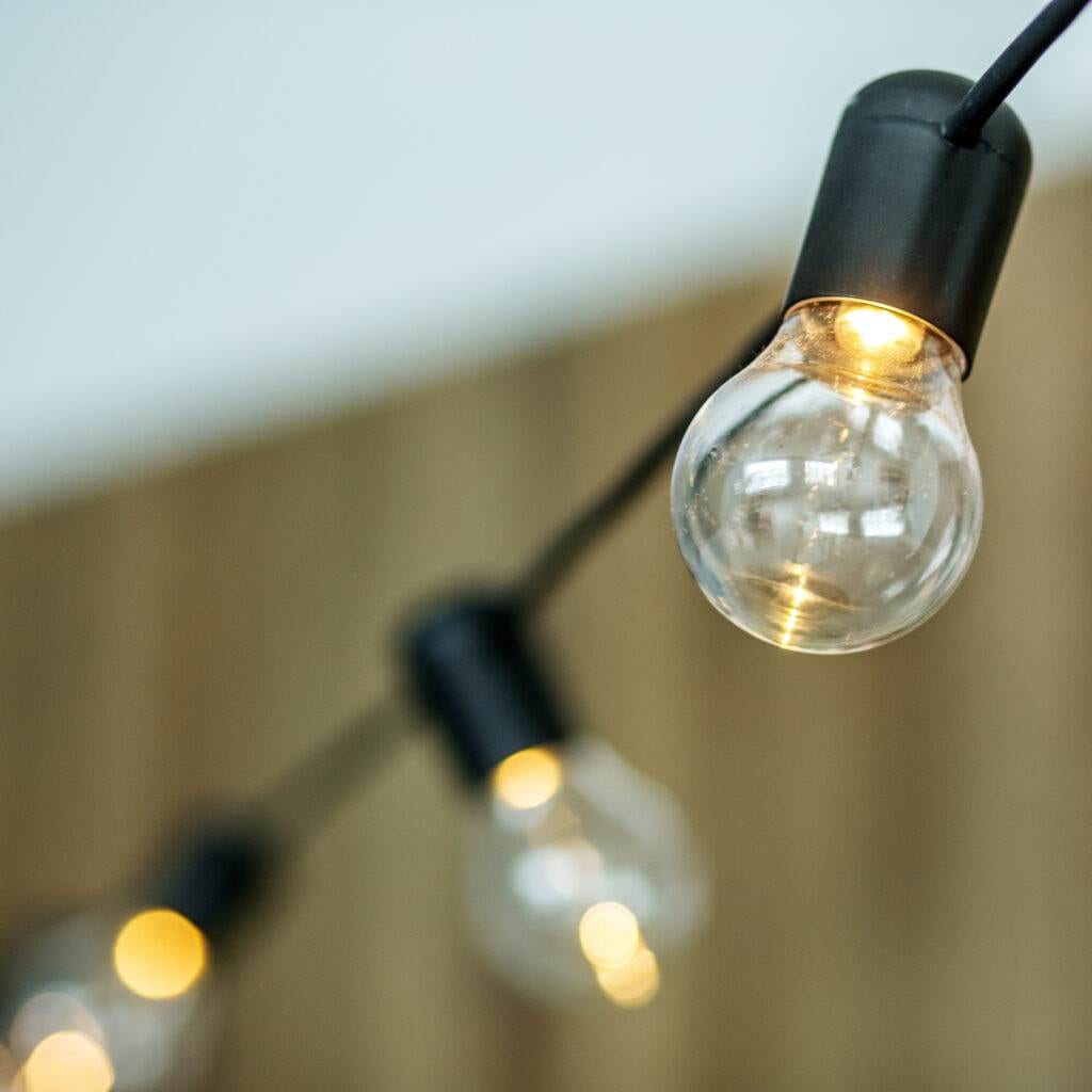 a string of lights with a clear light bulb